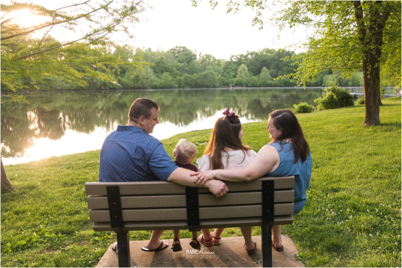 Image of family looking at each on park bench