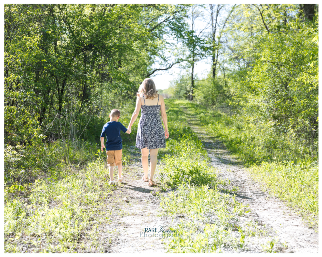 Image of mom and son hand-in-hand walking