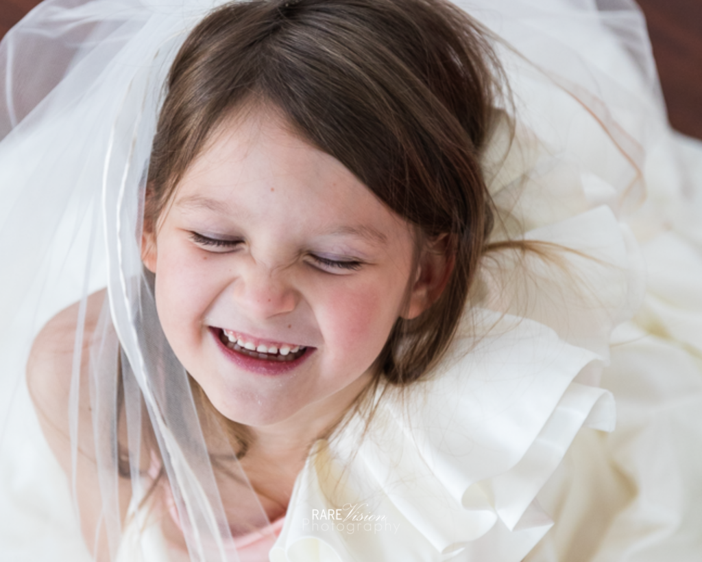 Image of girl smiling with eyes closed during dress up session