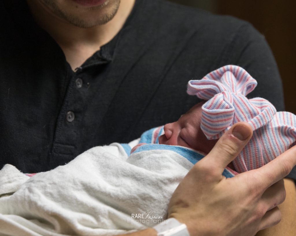 Image of dad holding daughter