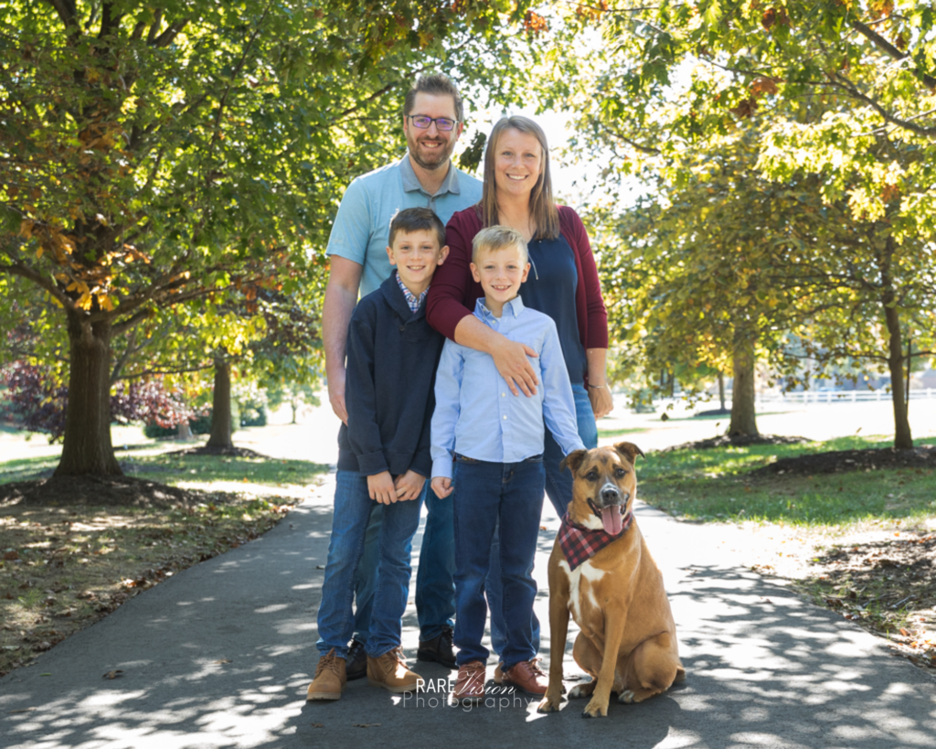 Image of the Hartley family on tree-lined path