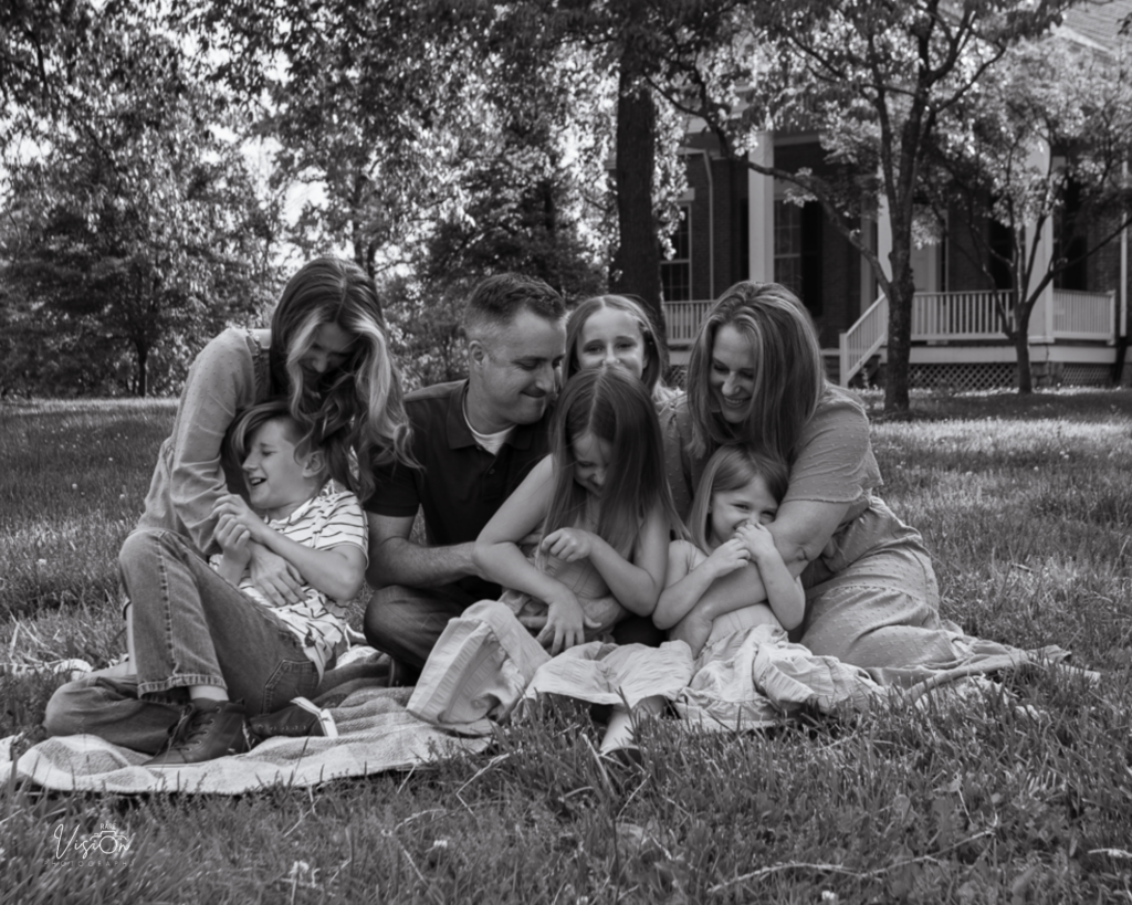 Image of family in lawn during tickle fight