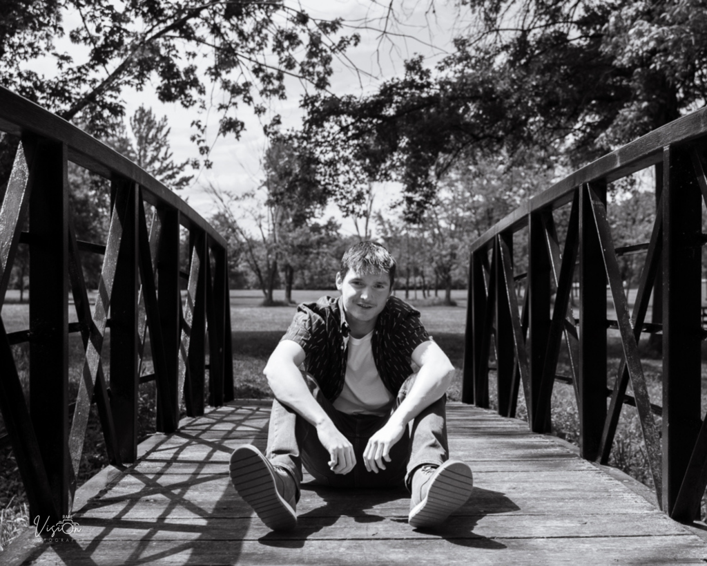 Young man sitting on bridge - Fenton City Park