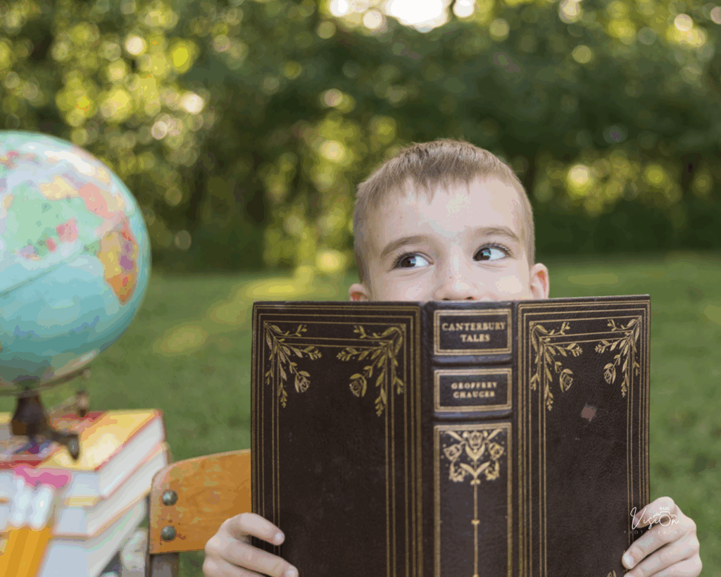 Image of boy looking up from book
