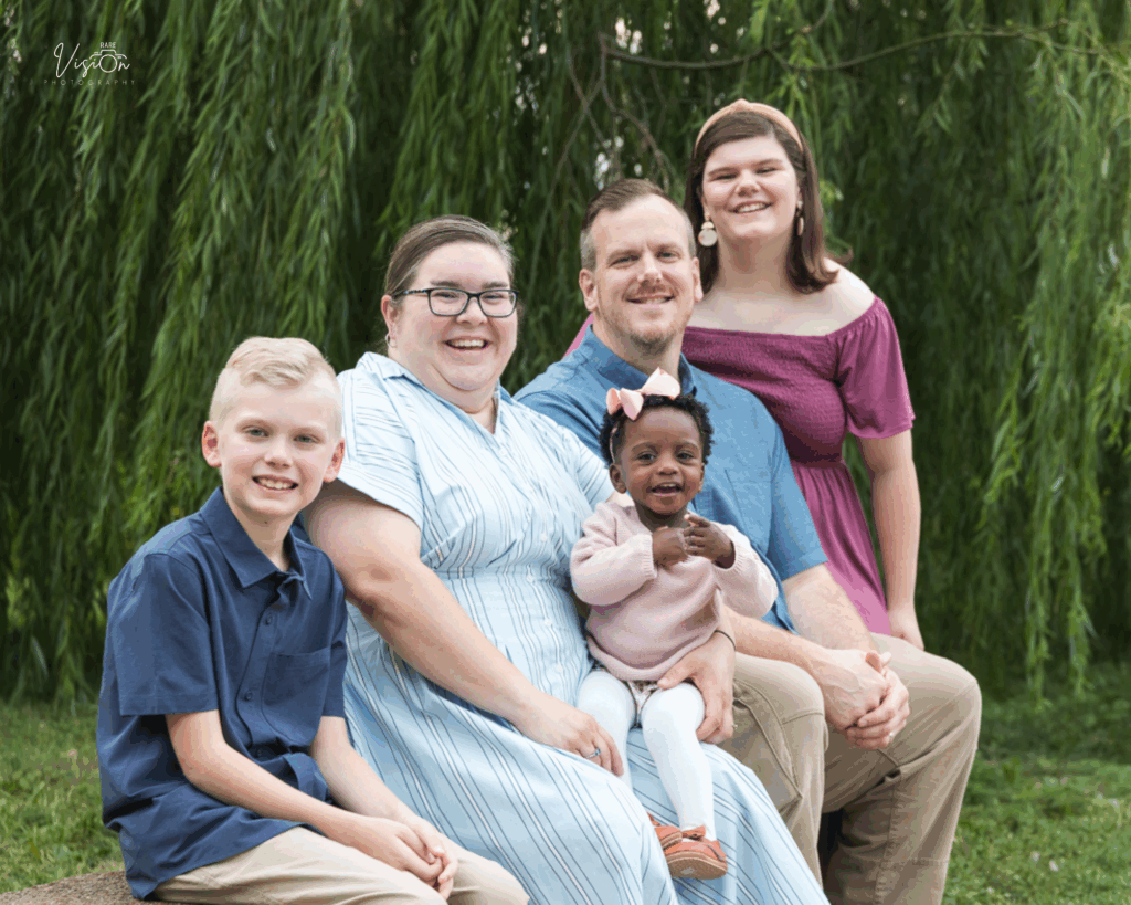Image of family in front of weeping willow tree at Tower Grove Park