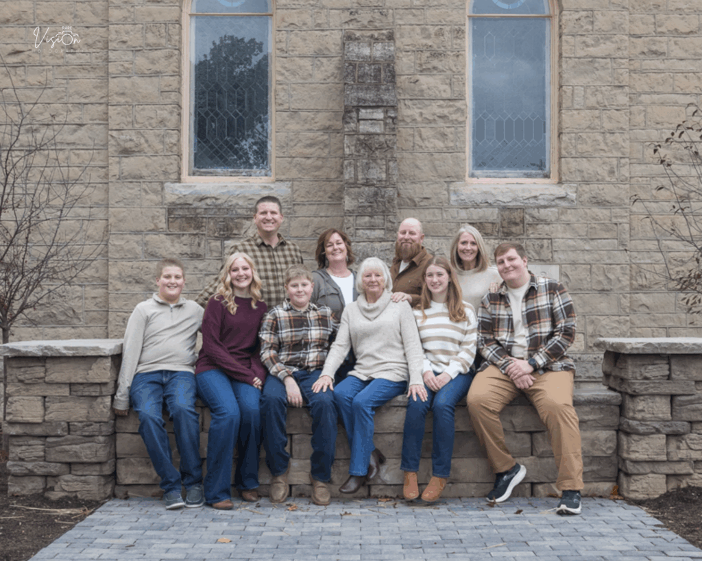 Extended family, some sitting, in front of church