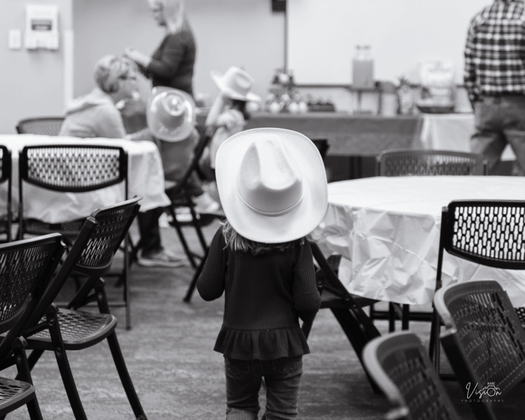 Image of girl walking away from camera with cowboy hat