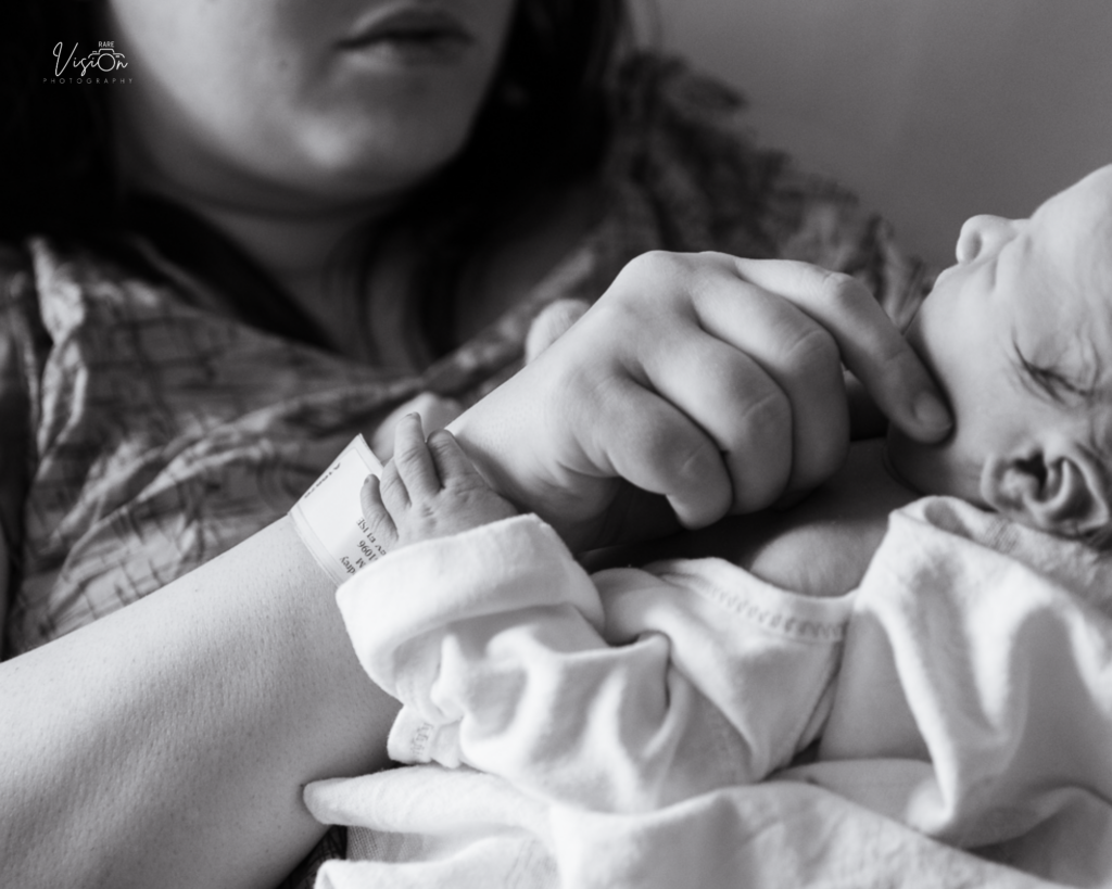 Image of baby holding mom's wrist