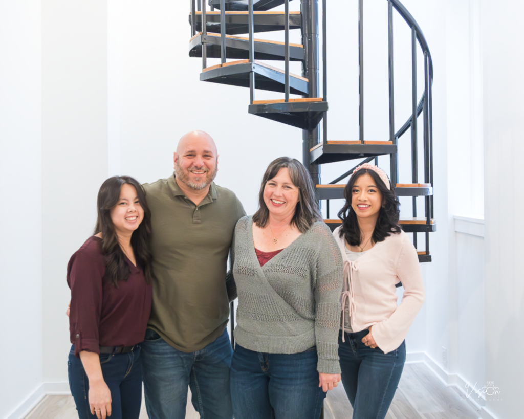 Image of the Frey Family in front of spiral staircase
