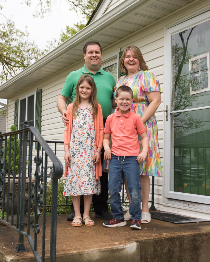 Image of my family smiling in front of the house on Easter morning