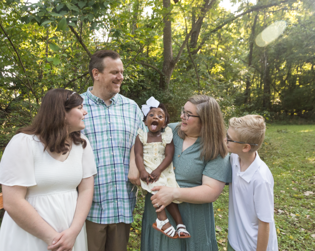 Images of family looking at youngest